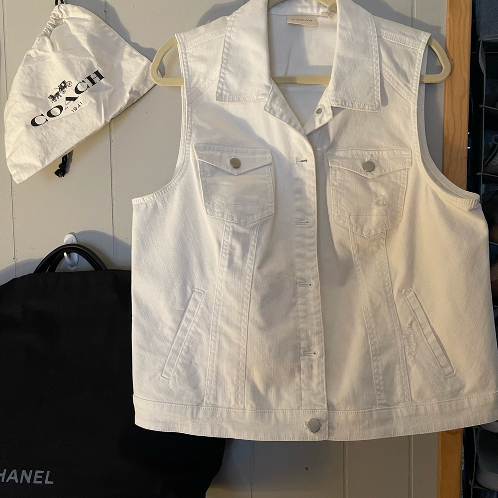 A white jean vest brand Chico size 3 fits like a large